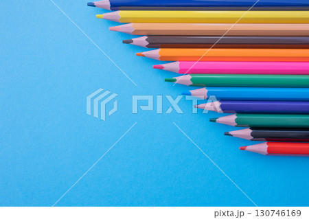 A lot of color pencils on the bright blue paper background. Close up. Design concept. Space for text. A lot of color pencils on the bright blue paper background. Close up. Design concept. Space for text. 130746169