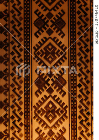 Traditional geometric ethnic wooden pattern with warm ambient lighting 130746410