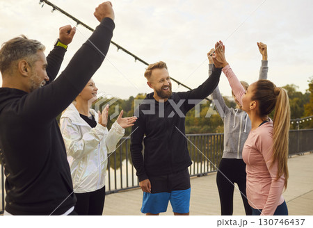 Friends in Sport Giving High Five during Outdoor Workout 130746437