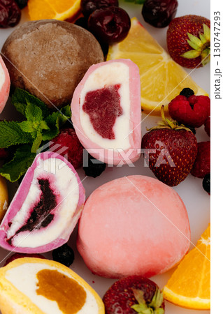 Colorful mochi ice cream with fresh fruits and berries on white background, close up Colorful mochi ice cream with fresh fruits and berries on white background, close up 130747293