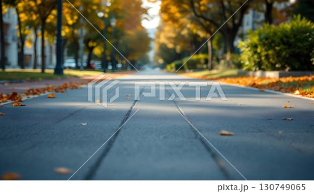A scenic running track with green grass and trees in the background, ideal for springtime outdoor exercise 130749065