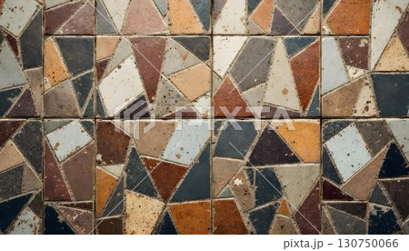 A delightful wall adorned with a variety of vibrant tiles, showcasing a textured design and bright hues 130750066