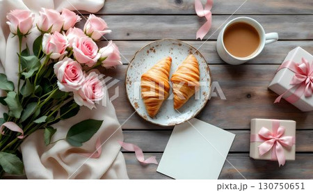 A Valentine's Day visual that highlights croissants, roses, and a gift box, embodying the spirit of romance and thoughtful gifting 130750651