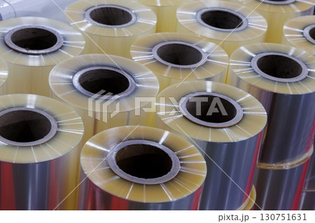 Close-up of clear food grade plastic film ready to use in packing machine for wraping industrial and consumer product packaging at food mufaturing. materials prepared for industrial use in factory 130751631