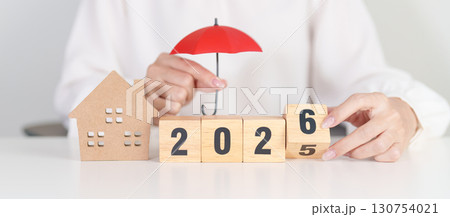 Happy New Year 2026 with red umbrella over money stack. Insurance, real estate, Home loan, tax, investment, mortgage, financial, savings, protection and safety Happy New Year 2026 with red umbrella over money stack. Insurance, real estate, Home loan, tax, investment, mortgage, financial, savings, protection and safety 130754021