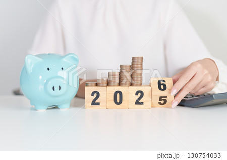 2025 end year to Happy New Year 2026 with piggy bank. Resolution, Goals, Plan, Action, Money Saving, Retirement fund, Pension, Investment and Financial concepts 130754033