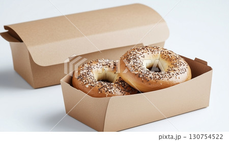 Breakfast bagel on brown paper craft take away disposable bowl in ceramic white table 130754522
