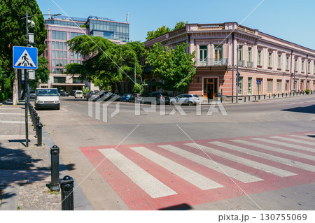 Busy city intersection with modern buildings and classic architecture on a sunny day 130755069
