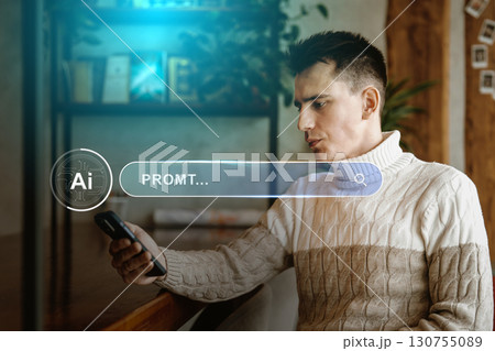 Young man engaging with smartphone in a cozy indoor setting while exploring digital content in the late afternoon 130755089