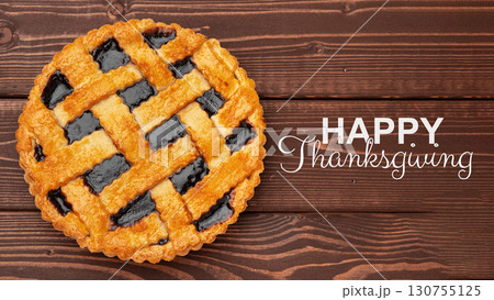 Delicious homemade pie served for Thanksgiving celebration with a wooden background 130755125