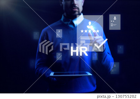 Human resources professional uses digital tools for employee evaluation and management in a modern workspace 130755202