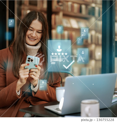 Happy woman using smartphone for online reviews in a cozy library coffee shop Happy woman using smartphone for online reviews in a cozy library coffee shop 130755228