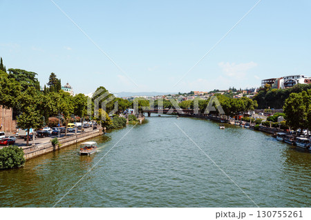 Serenity of the river gracefully flowing through a lively urban landscape in summer 130755261