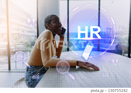 Young professional engaged in a phone call discussing HR strategies during a modern office meeting 130755282