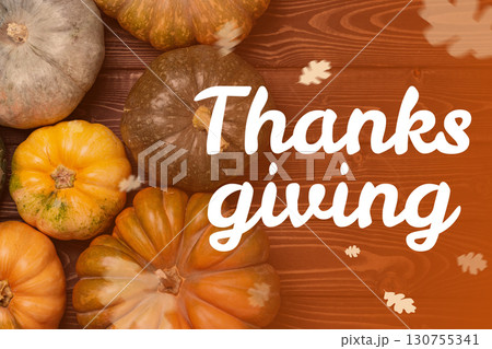 Thanksgiving celebration featuring various pumpkins arranged on a wooden background 130755341