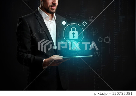 Professional man using tablet with digital security icons in a dark environment for online safety solutions Professional man using tablet with digital security icons in a dark environment for online safety solutions 130755381