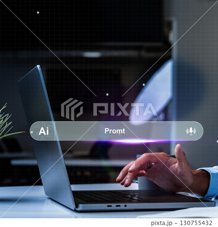 Person typing on laptop with AI interface in a modern workspace at night 130755432
