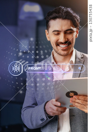 Man in suit smiling while using tablet in a modern office environment during daytime as he searches for information Man in suit smiling while using tablet in a modern office environment during daytime as he searches for information 130755438