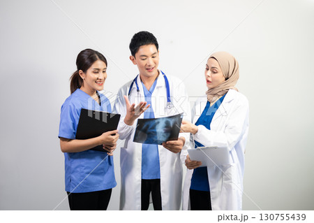Successful team of medical doctors looking at camera and smiling while standin. Health, professional and people team in white background 130755439