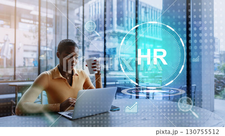 Focused young professional working on human resources tasks in a modern office space while enjoying a coffee Focused young professional working on human resources tasks in a modern office space while enjoying a coffee 130755512
