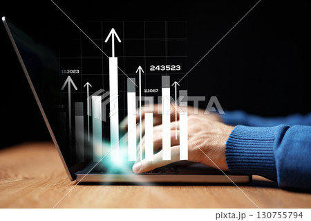 Data analysis and business growth tracking happening on a laptop computer at a modern workspace 130755794