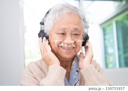 Asian senior woman patient happy to use earphone to listen relax music. Asian senior woman patient happy to use earphone to listen relax music. 130755857