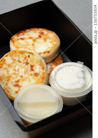 Delicious flatbreads served with creamy dips in a black food container perfect for a snack or light meal 130755934