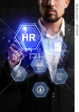 Business professional interacting with human resources digital interface in an office setting during evening hours 130755938