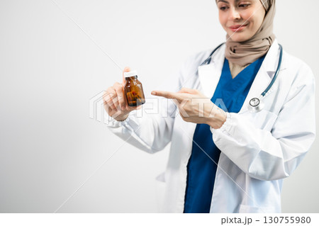 Hand in a Lab Coat and a holding a white pill bottle Hand in a Lab Coat and a holding a white pill bottle 130755980
