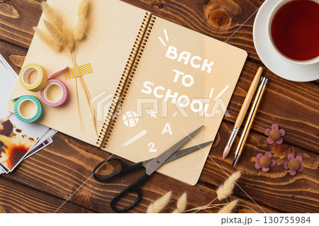 Crafting supplies and notebook prepare for back to school season in cozy workspace setting with tea nearby Crafting supplies and notebook prepare for back to school season in cozy workspace setting with tea nearby 130755984