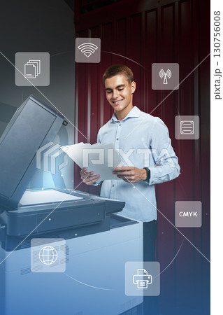 Young professional using printer in modern office, exploring digital printing features in vibrant workspace 130756008