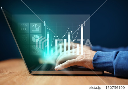 Data analysis and financial metrics displayed on laptop screen with user interaction in a modern workspace Data analysis and financial metrics displayed on laptop screen with user interaction in a modern workspace 130756100