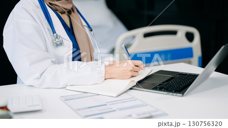 Medical technology concept. Doctor working with mobile phone and stethoscope and digital tablet laptop in modern office at hospital Medical technology concept. Doctor working with mobile phone and stethoscope and digital tablet laptop in modern office at hospital 130756320