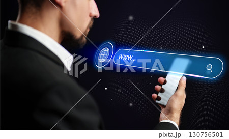 Man using smartphone to search on the internet with a digital interface at night Man using smartphone to search on the internet with a digital interface at night 130756501