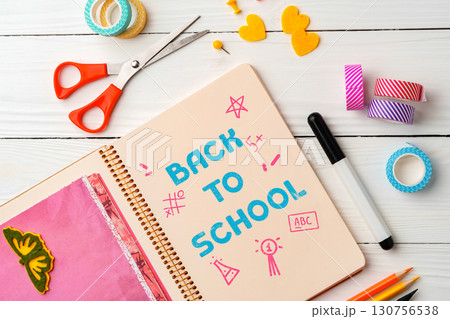 Creative back to school preparation with colorful supplies and stationery on a wooden table Creative back to school preparation with colorful supplies and stationery on a wooden table 130756538