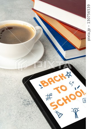 Coffee, books, and a tablet showing back to school preparations on a workspace 130756539