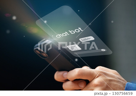 User interacting with a virtual chat bot on a smartphone screen during evening hours 130756659