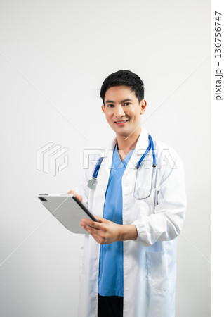 Man portrait of a doctor wearing a white coat and a stethoscope looking into the camera on a white isolated background 130756747