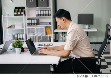 Group of professionals in an office discussing strategy, analyzing data, and collaborating on projects Group of professionals in an office discussing strategy, analyzing data, and collaborating on projects 130756899