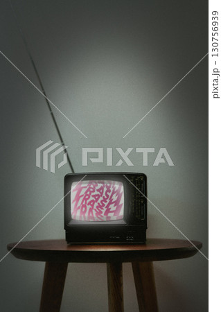 Vintage television set displaying static with colorful text on screen in dimly lit room Vintage television set displaying static with colorful text on screen in dimly lit room 130756939