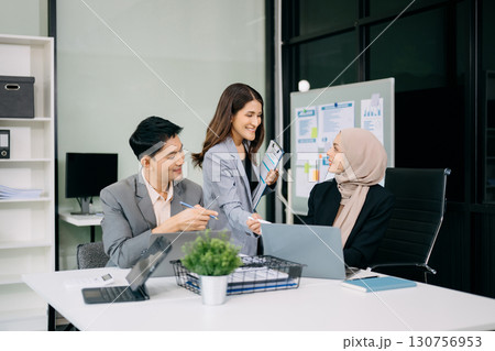 Group of professionals in an office discussing strategy, analyzing data, and collaborating on projects Group of professionals in an office discussing strategy, analyzing data, and collaborating on projects 130756953