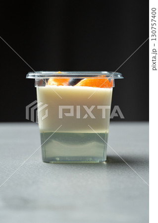 Creamy dessert cup with layers of flavor and fruit topping on a neutral background Creamy dessert cup with layers of flavor and fruit topping on a neutral background 130757400