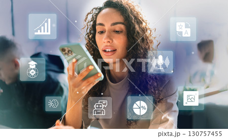 Woman engaged with smartphone while interacting with technology in a modern learning environment Woman engaged with smartphone while interacting with technology in a modern learning environment 130757455