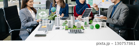 Business people having consultation about wind energy at company office. Business team discussing about windmill and alternative green enery. Executive meeting 130757861