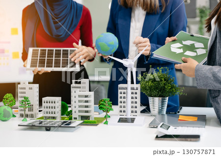 business team people planning and discussing on recycle reduce reuse policy symbol in office meeting room. Green business company and Solar Energy Environment city 130757871