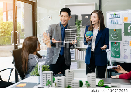 Business people having consultation about wind energy at company office. Business team discussing about windmill and alternative green enery. Net zero and carbon neutral 130757973
