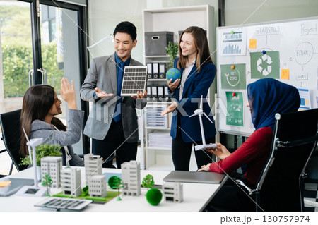 Business people having consultation about wind energy at company office. Business team discussing about windmill and alternative green enery. Net zero and carbon neutral 130757974