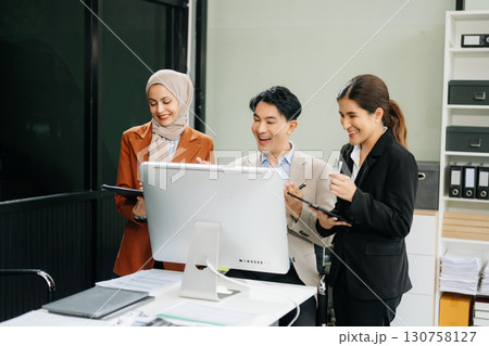 Asian businesspeople while collaborating on a new project. using a laptop and tablet Asian businesspeople while collaborating on a new project. using a laptop and tablet 130758127