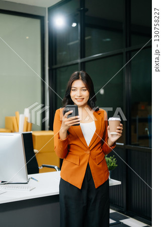 Woman Entrepreneur: SME Business mastering e-commerce with tablet, laptop, packaging, Woman Entrepreneur: SME Business mastering e-commerce with tablet, laptop, packaging, 130758227