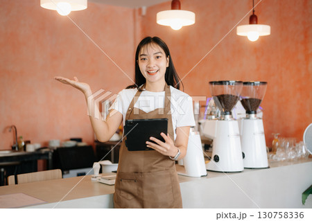 Startup successful small business owner sme woman stand with tablet  in cafe 130758336
